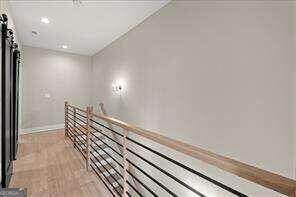 interior space with baseboards, recessed lighting, and wood finished floors