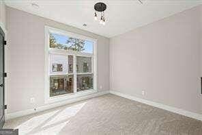 unfurnished room featuring baseboards and carpet flooring