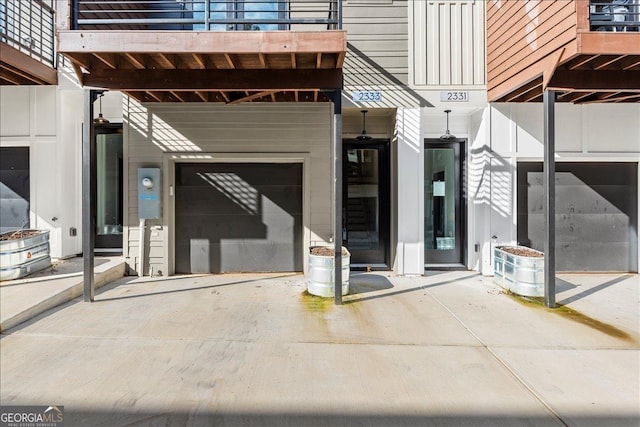 view of exterior entry with a balcony