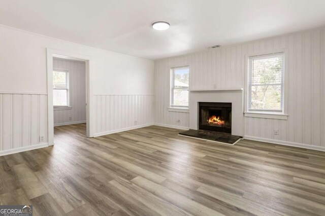 3556 Finch Rd SW, Powder Springs, GA 30127 - unfurnished living room with wood finished floors and a warm lit fireplace