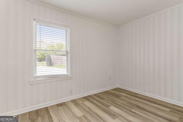 3556 Finch Rd SW, Powder Springs, GA 30127 - empty room with light wood-style floors, crown molding, and baseboards