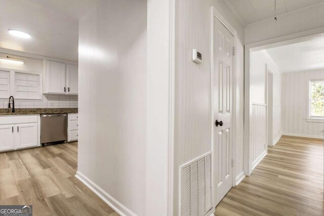 3556 Finch Rd SW, Powder Springs, GA 30127 - corridor featuring light wood-style floors, baseboards, and a sink