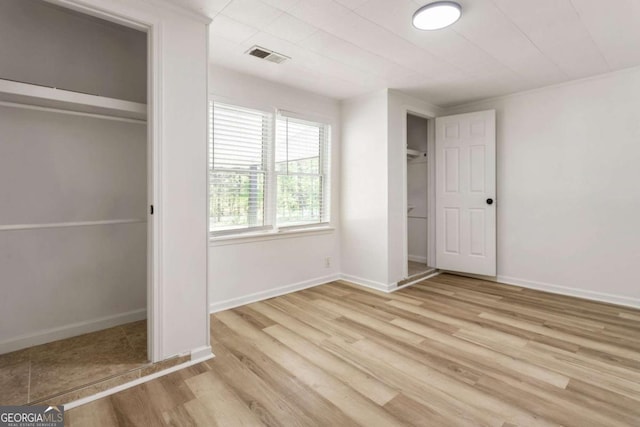 3556 Finch Rd SW, Powder Springs, GA 30127 - unfurnished bedroom with wood finished floors, a closet, and baseboards