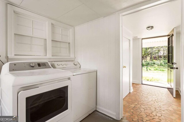 3556 Finch Rd SW, Powder Springs, GA 30127 - washroom featuring separate washer and dryer, stone finish flooring, and baseboards