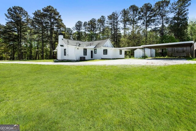 3556 Finch Rd SW, Powder Springs, GA 30127 - view of front of house featuring a front yard, a chimney, dirt driveway, and a carport