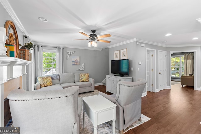 living area featuring plenty of natural light, baseboards, and ceiling fan