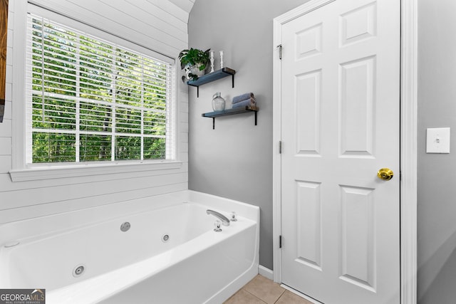 full bathroom with tile patterned flooring and a tub with jets