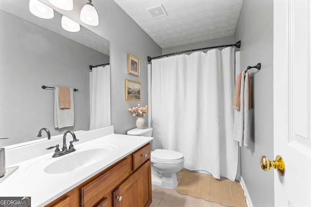 bathroom featuring a textured ceiling, vanity, toilet, tile patterned flooring, and visible vents