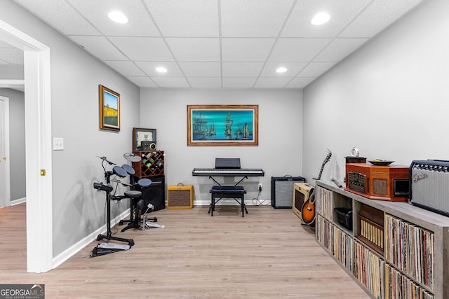 interior space featuring light wood finished floors, a paneled ceiling, baseboards, and recessed lighting