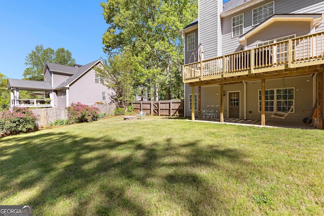 view of yard with a fenced backyard and a deck
