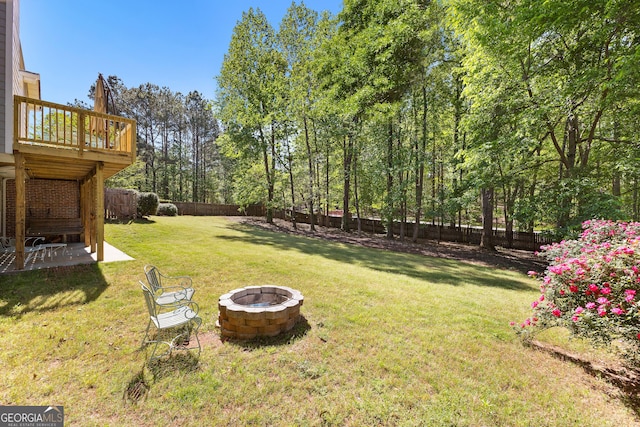 view of yard featuring a fire pit, a patio, and a fenced backyard