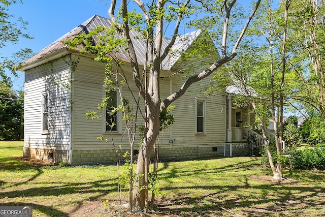 view of property exterior with a lawn and crawl space