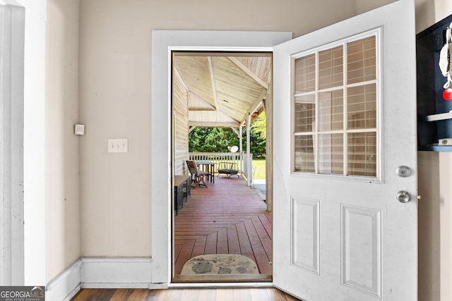 doorway to outside featuring parquet flooring