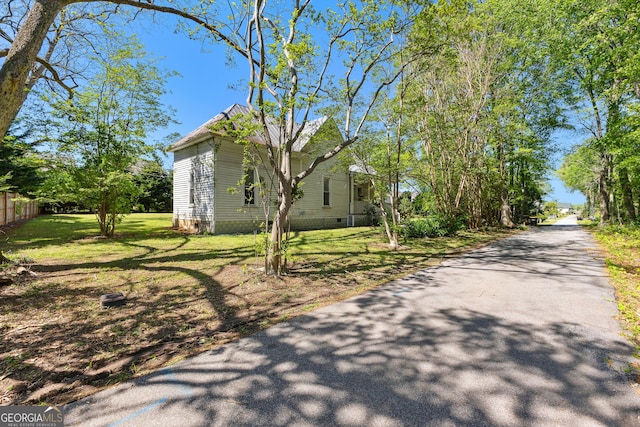 exterior space featuring fence, crawl space, and a yard