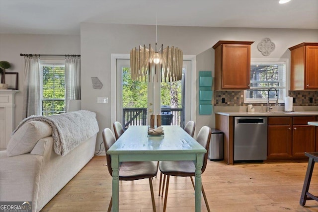 dining room featuring recessed lighting, light wood-style flooring, and a wealth of natural light