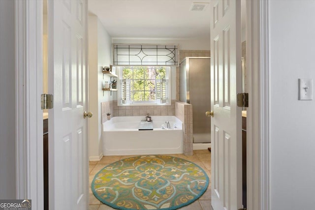 full bathroom with visible vents, tile patterned flooring, a bath, and a stall shower