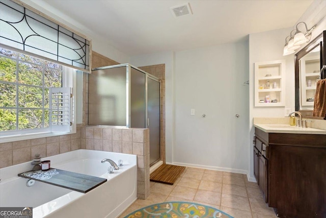 bathroom with vanity, a stall shower, a bath, and visible vents
