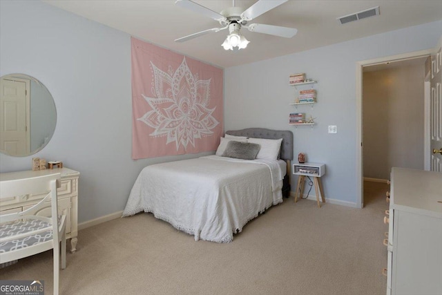 bedroom featuring baseboards, visible vents, light carpet, and ceiling fan