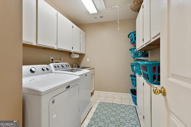 laundry area with independent washer and dryer, cabinet space, a sink, baseboards, and visible vents
