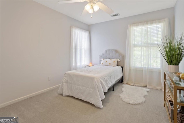 bedroom with multiple windows, carpet, and visible vents