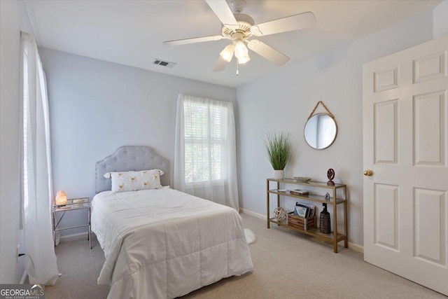 carpeted bedroom with baseboards, visible vents, and ceiling fan