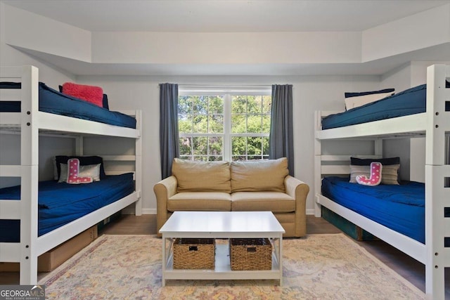 bedroom with baseboards and wood finished floors