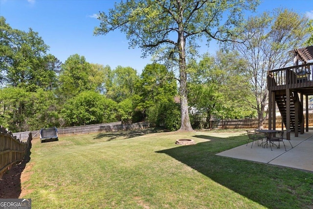 view of yard with a patio, a fire pit, stairs, and a fenced backyard