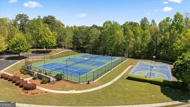 view of sport court featuring a lawn and fence