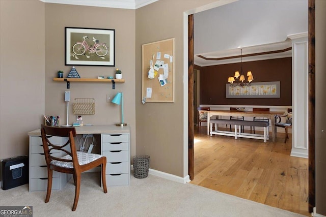 office space featuring baseboards, a notable chandelier, ornamental molding, and wood finished floors