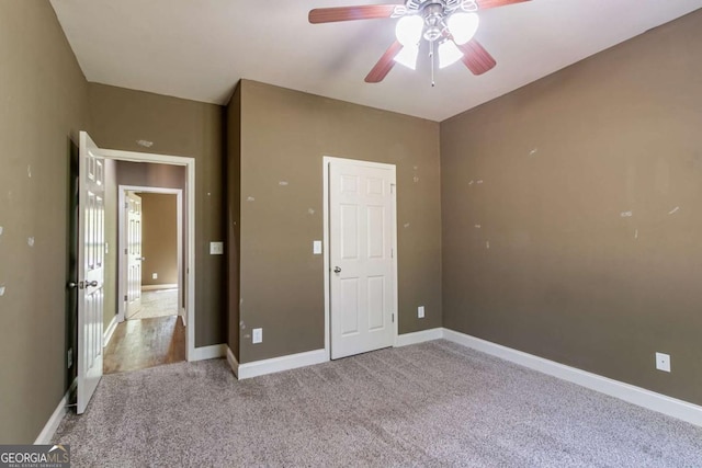100 Hickory Dr, Stockbridge, GA 30281 - unfurnished bedroom featuring light carpet, a ceiling fan, and baseboards