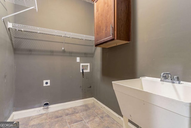 100 Hickory Dr, Stockbridge, GA 30281 - clothes washing area featuring a sink, hookup for an electric dryer, cabinet space, baseboards, and washer hookup