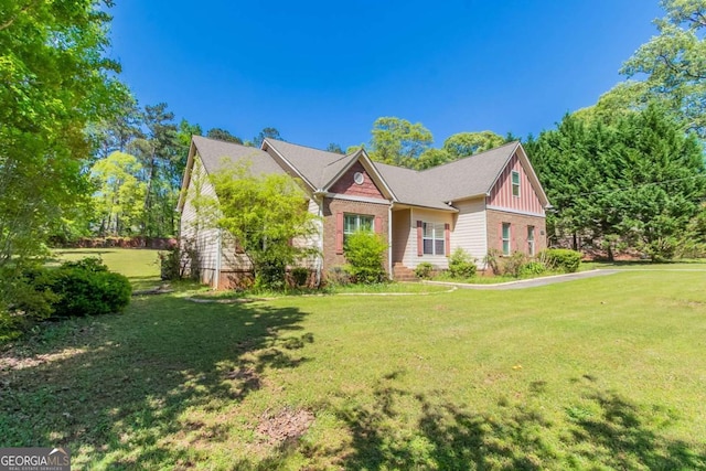 100 Hickory Dr, Stockbridge, GA 30281 - view of front facade featuring brick siding, board and batten siding, and a front yard