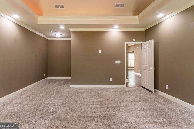 100 Hickory Dr, Stockbridge, GA 30281 - carpeted spare room with a tray ceiling, visible vents, crown molding, and baseboards