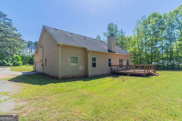 100 Hickory Dr, Stockbridge, GA 30281 - rear view of house featuring a chimney, a wooden deck, crawl space, driveway, and a lawn
