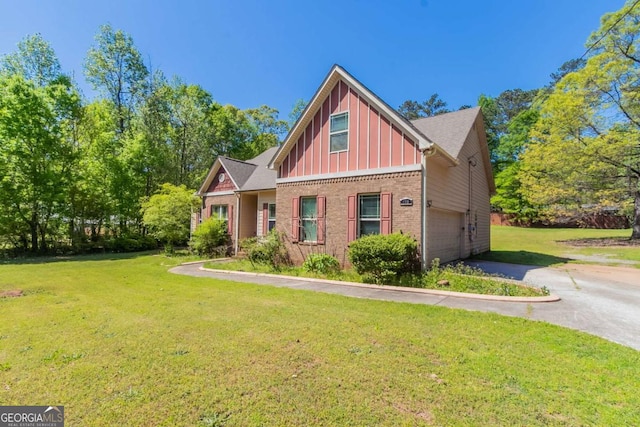 100 Hickory Dr, Stockbridge, GA 30281 - craftsman-style house with brick siding, a garage, board and batten siding, a front yard, and aphalt driveway