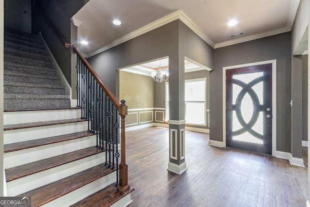 100 Hickory Dr, Stockbridge, GA 30281 - entryway featuring wood finished floors, stairs, an inviting chandelier, ornamental molding, and visible vents