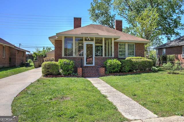 5 NE Poplar St NE, Rome, GA 30161 - bungalow featuring a chimney, a front lawn, driveway, fence, and brick siding