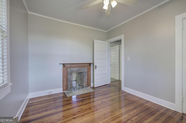 5 NE Poplar St NE, Rome, GA 30161 - unfurnished living room with a stone fireplace, a ceiling fan, ornamental molding, and wood finished floors