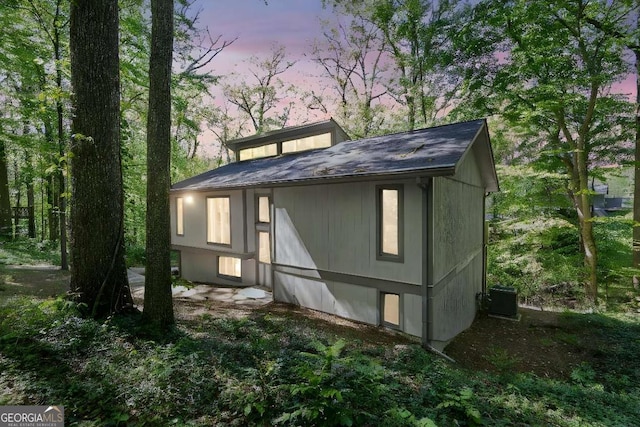 property exterior at dusk featuring central AC