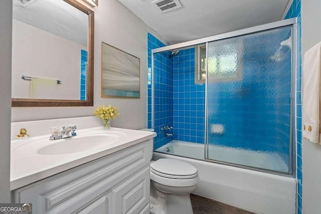 full bathroom with visible vents, enclosed tub / shower combo, vanity, and toilet
