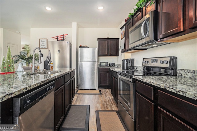 129 Coldwater Way, Griffin, GA 30224 - kitchen featuring a sink, stone counters, light wood finished floors, and stainless steel appliances