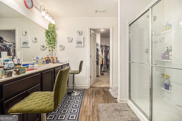 129 Coldwater Way, Griffin, GA 30224 - full bath featuring a spacious closet, vanity, a stall shower, and wood finished floors