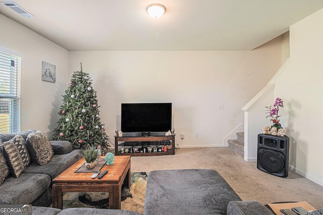 129 Coldwater Way, Griffin, GA 30224 - living area with carpet floors, baseboards, visible vents, and stairway