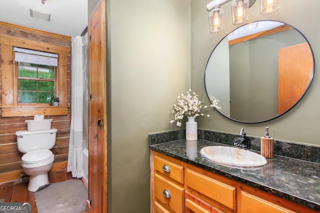 bathroom with wood finished floors, visible vents, toilet, vanity, and a shower with shower curtain