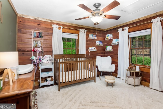 bedroom featuring wood walls and ceiling fan