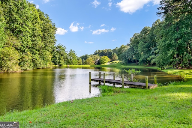 dock area featuring a lawn and a water view