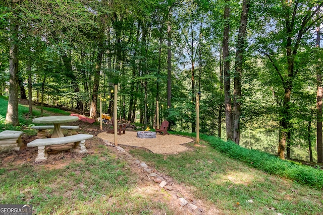 view of yard with a fire pit