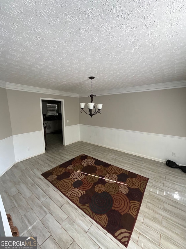 1086 Deshon Trl, Lithonia, GA 30058 - corridor with a chandelier, a wainscoted wall, wood finish floors, a textured ceiling, and crown molding
