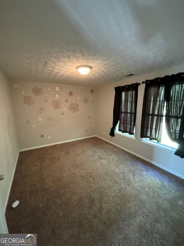 1086 Deshon Trl, Lithonia, GA 30058 - empty room with baseboards, a textured ceiling, and dark carpet