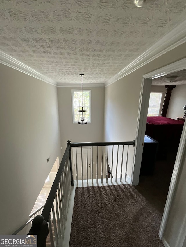 1086 Deshon Trl, Lithonia, GA 30058 - hallway featuring an upstairs landing, ornamental molding, carpet flooring, baseboards, and a textured ceiling